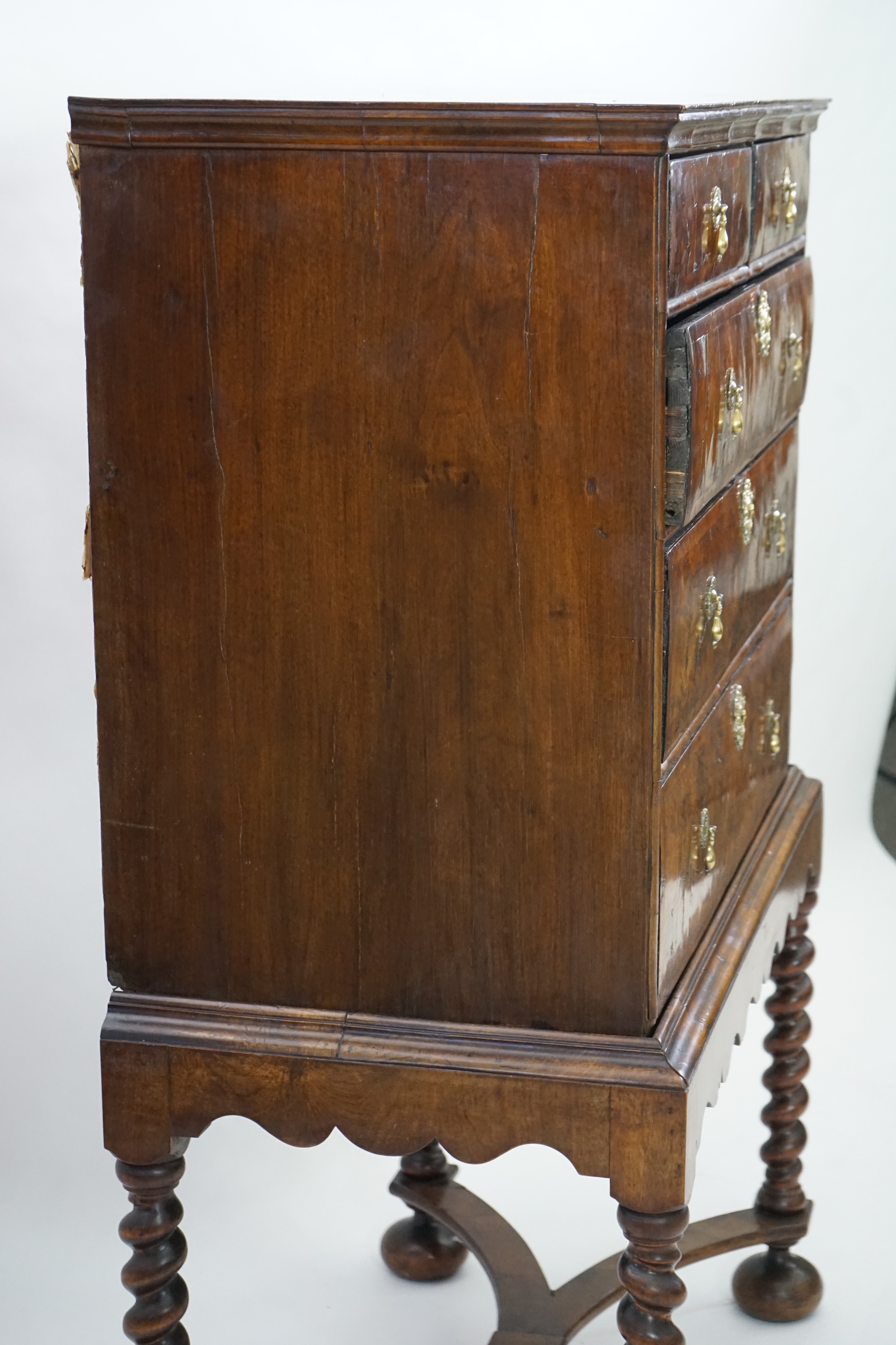 An early 18th century and later crossbanded walnut chest on stand